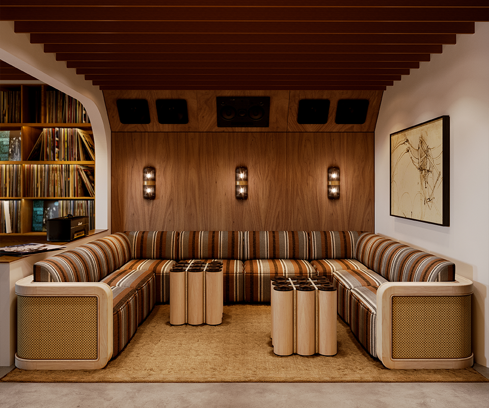 A luxurious mid-century modern lounge featuring a large U-shaped Kimberley Sofa upholstered in a retro striped earth-tone fabric with woven rattan side panels. In the center sit two Kensington Tic-Tac-Toe Tables crafted from light wood cylinders. The wood-paneled back wall is accented by three Turing Wall Lamps with dark glass shades and gold details, casting a warm glow over the seating area. The space is completed by a slatted ceiling, a tan area rug, and a built-in vinyl record library in the background.