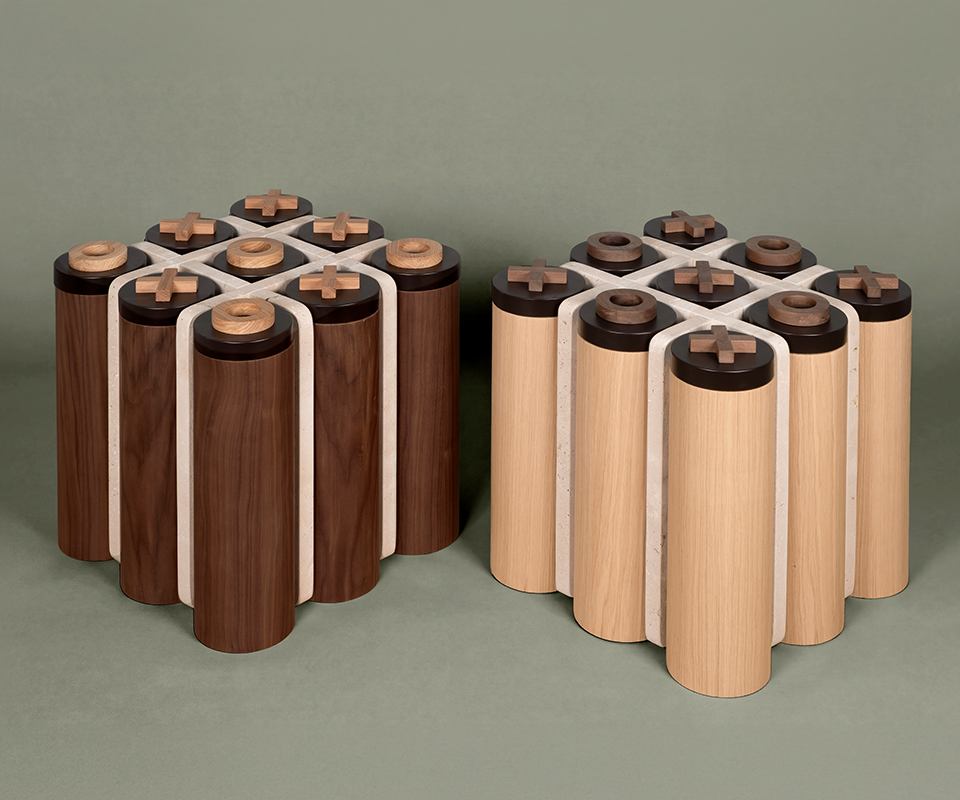 Two Kensington Tic-Tac-Toe side tables by Wood Tailors on a sage green background: a walnut version with oak pieces and an oak version with walnut pieces.
