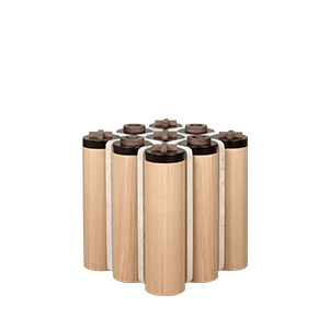 Close-up of the Kensington Tic-Tac-Toe table by Wood Tailors, showing walnut X and O pieces on black lids above oak cylinders and a travertine grid.