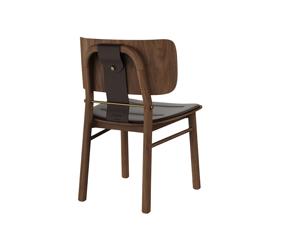 Arthur Dining Chair Back three-quarter view of the Arthur Dining Chair in dark walnut wood, highlighting the dark brown leather upholstered seat, curved wooden backrest, dark saddle leather back strap, and aged brushed brass bar and button detail.