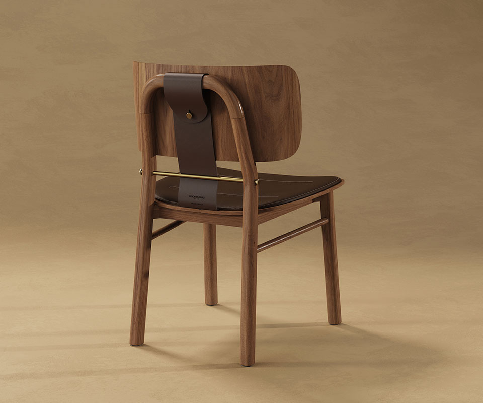 Arthur Dining Chair Studio shot from behind the Arthur Dining Chair in dark walnut, focusing on the craftsmanship of the leather strap, brass bar, and wooden frame.