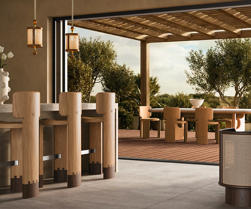 Benjamin Dining Chair Modern luxury outdoor patio dining area featuring the Benjamin Dining Chair and Portman Dining Table on a wooden deck. Inside, three wooden Benjamin Bar Chairs sit at a stone bar counter under Hamilton Pendant Lamps. A Wodehouse Sideboard decorated with a Hamilton Table Lamp completes the warm, minimalist indoor-outdoor setting.