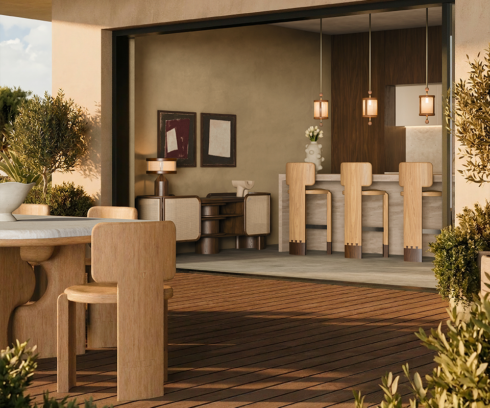 Benjamin Dining Chair Close-up of three wooden Benjamin Bar Chairs with distinctive dark wood base details lined up at a stone bar counter, illuminated by two hanging Hamilton Pendant Lamps. Through the open sliding doors, the outdoor terrace shows the Portman Dining Table paired with Benjamin Dining Chairs under a wooden pergola.