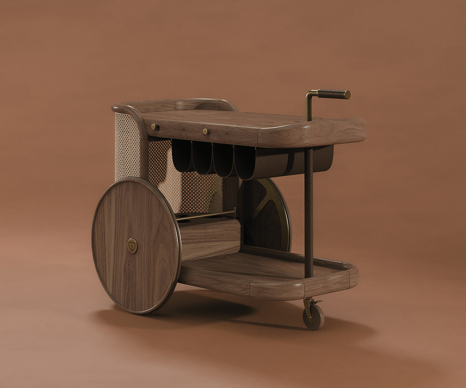 Brinsley Bar Cart The New Icon Brinsley Bar Cart at a 45° angle, highlighting the natural rattan weave, walnut wood frame, and wooden wheels, set against a warm brown background that emphasizes its textures and craftsmanship.