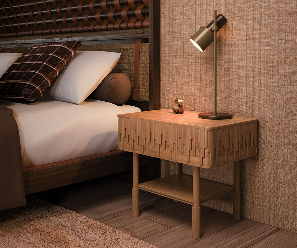 Campbell bedside table in oak wood paired with a Herschel table lamp. O'Connell II Bed with a headboard featuring leather details in Prestige fabric from Élitis, set in a bedroom with Élitis Abaca wallpaper and Ralph Lauren Wallace throw pillows.