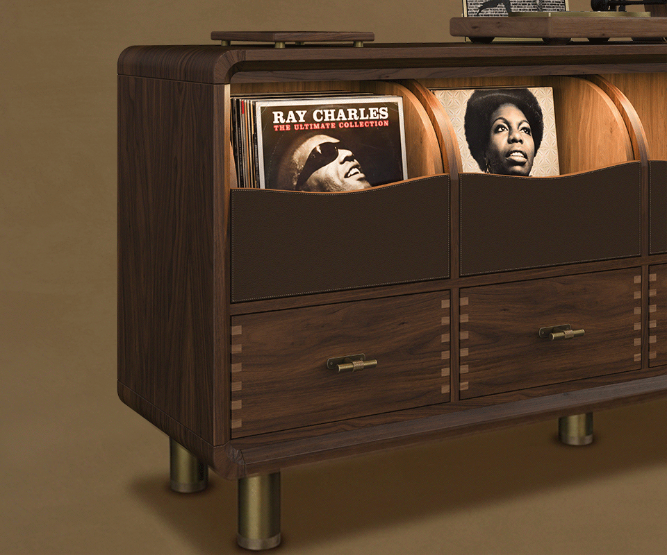 Edward Sideboard Deatil tree-quarter view of the Edward Sideboard by Wood Tailors Club crafted in dark stained smoked walnut, displaying vinyl storage compartments, drawers with brass hardware.