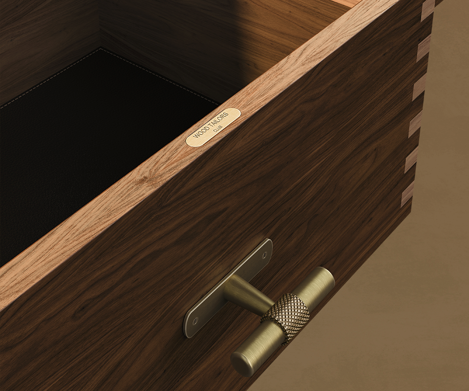 Edward Sideboard Close-up view looking into an open walnut drawer of the Edward Sideboard, highlighting its dark leather lining, dovetail corner joints, T-bar brass handle, and an engraved "Wood Tailors Club" brass plaque along the top edge.