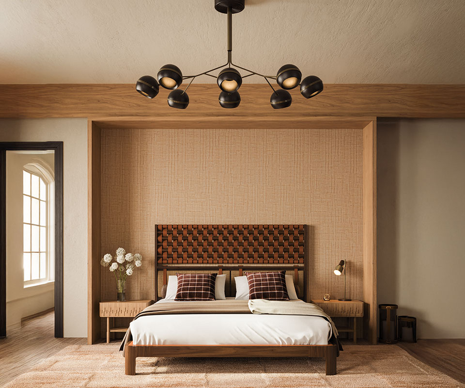 Fleming Suspension Lamp in smoked walnut wood and O'Connell II Bed with a headboard featuring leather details in Prestige fabric from Élitis, set in a bedroom with Élitis Abaca wallpaper, a rug by Kelly Wearstler, and Ralph Lauren Wallace throw pillows. The space also includes a Faraday wall lamp.