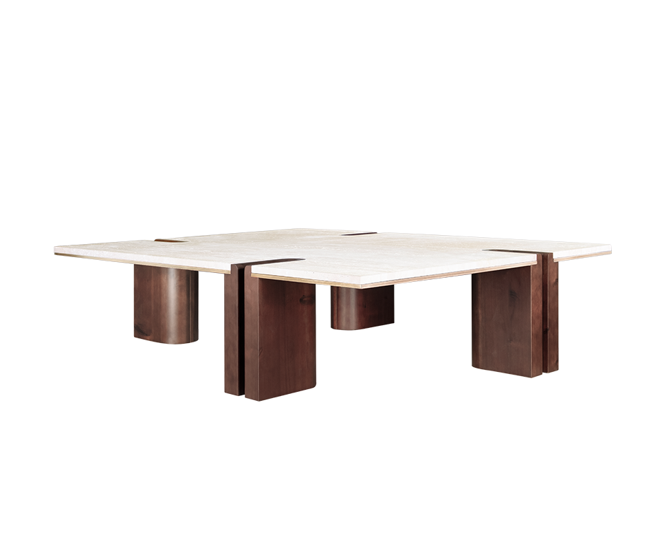 A three-quarter perspective view of the Grenville Center Table, showcasing its low profile and massive scale. The dark smoked walnut legs are positioned at different angles, with the U-shaped cutouts visible on multiple sides, creating a rhythmic, interlocking look with the travertine slab.