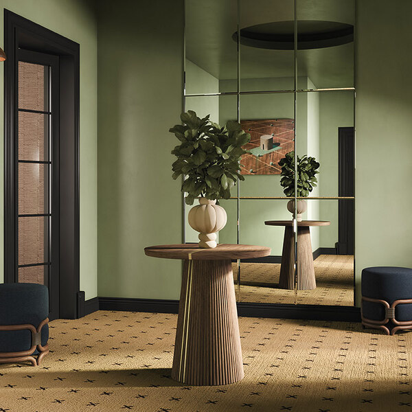 Interior design scene featuring a wall mirror, a Henry II dining table as a wooden statement piece with a decorative vase, two Stefan stools, and a Faraday wall lamp, styled in natural tones.