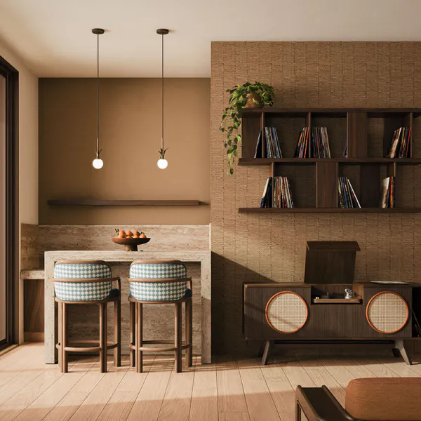 The James bar chair has a timeless design, upholstered in a blue and white checker-pattern fabric, is placed in a living room setting next to the Harrison sideboard, crafted in walnut and showcasing a vinyl record player inside. The space is complemented by two illuminated Berlin pendant lamps.