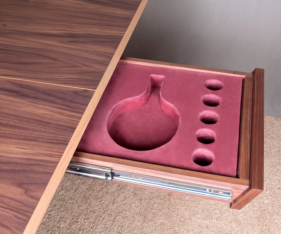 Keppel Ping-Pong Table Close-up view of an open wooden side drawer on the Keppel Ping Pong Table, featuring a custom-molded pinkish-burgundy velvet interior designed with tailored compartments to store table tennis paddles and five balls.