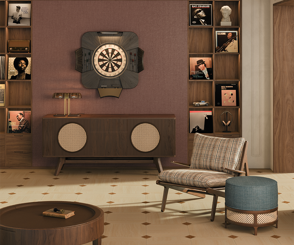 A serene living room bathed in soft daylight from the window, featuring the open new exquisite dartboard Rochford by Wood Tailors Club in black-stained ash wood with powder coated stainless steel details. The scene includes the Harrison sideboard, a Turing table lamp glowing gently above, a Moore armchair in textured fabric, and the George stool, creating a harmonious and refined interior.