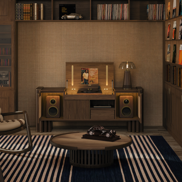 Dark walnut Ronnie Vinyl Sideboard set open in a warm, sophisticated living room with surrounding bookshelves, an illuminated top turntable compartment, and integrated side speakers. In the living room are also one William Rocking Chair, one Lloyd table lamp and Richard center table.