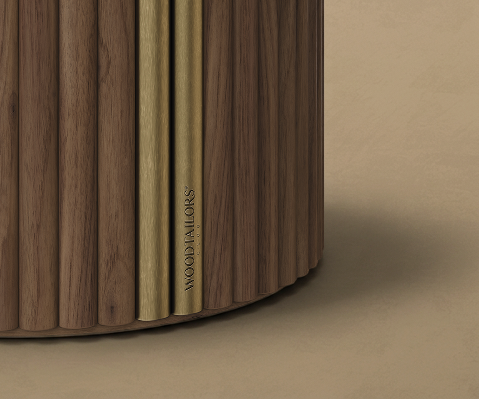 Extreme close-up shot of the Stuart I Dining Table's fluted wooden base, highlighting two vertical brushed brass metallic accents with the subtle engraved "WOOD TAILORS CLUB" branding.