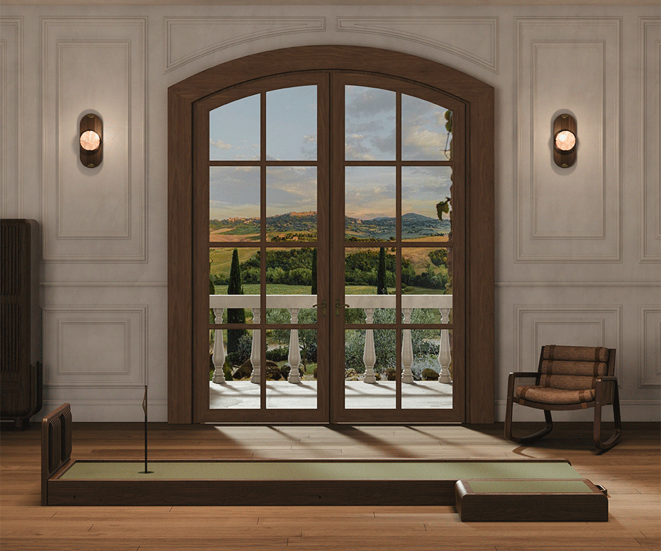 An interior lifestyle scene showing the Sutherland Mini Golf set placed in a luxury room with classic wall moldings and large arched French doors overlooking a scenic landscape.