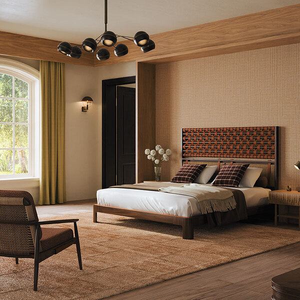 This bedroom furniture features O'Connell II Bed with a headboard featuring leather details in Prestige fabric from Élitis, set in a wooden bedroom with Élitis Abaca wallpaper, a rug by Kelly Wearstler, and Ralph Lauren Wallace throw pillows. The space also includes other bedroom furniture such as Adam armchair upholstered in Melbu 11093.52 fabric by Nobilis, a Fleming suspension lamp, and a Faraday wall lamp.